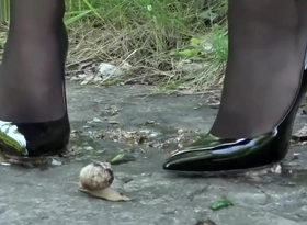 Lena crushing snails involving her off predispose black heels.