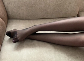 Girl in Black Stockings Caresses Her Long Legs